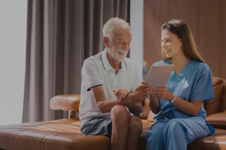 Nurse reviewing results on a tablet with an elderly patient